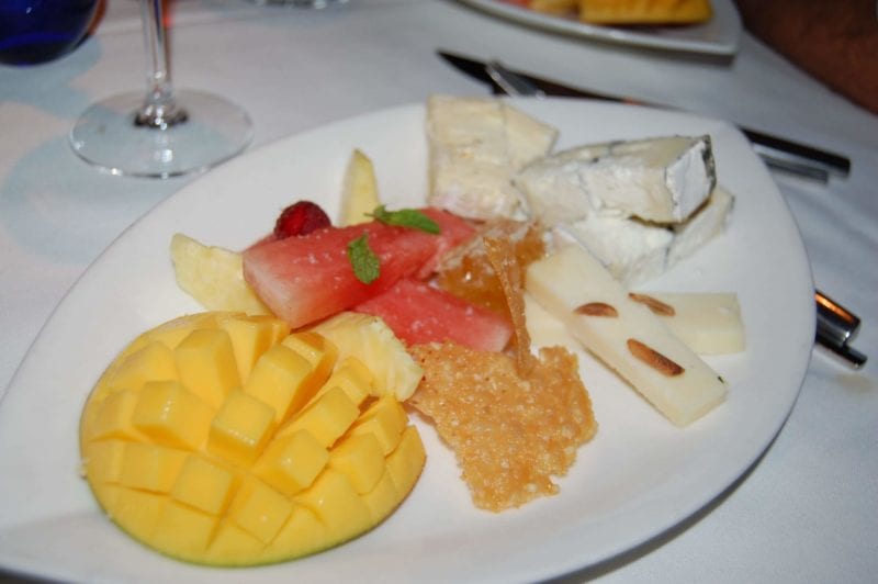 Plate of different cheeses, fruit, honeycomb, and Parmesan crisps from Upstream in North Carolina. 