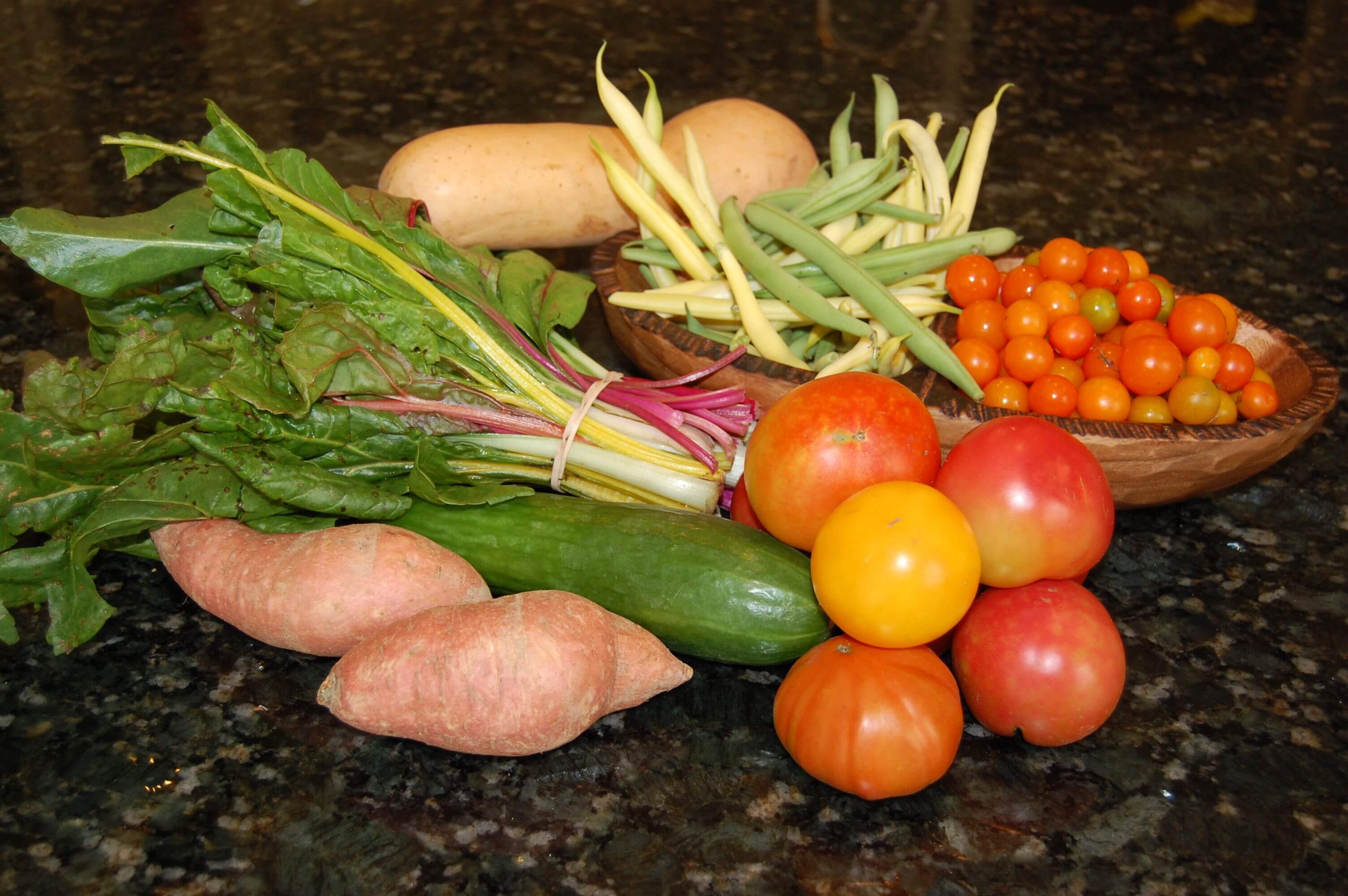 Fresh produce on the counter from the farmers market. 