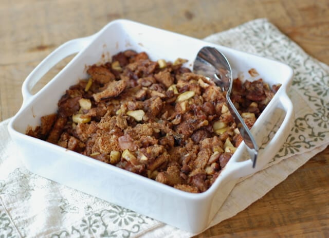 Chestnut and prosciutto bread stuffing in a white baking dish.