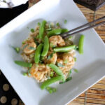Green Curry Shrimp topped with snap peas on top of brown rice