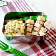 Lunchbox with egg salad and turkey with cheese sticks.