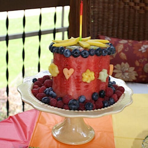 A fun watermelon cake with tons of fruit decorations