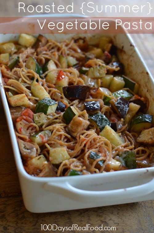 White backing dish with homemade baked pasta and summer vegetables. 