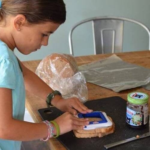 Young girl making homemade uncrustables.