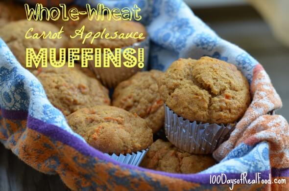A batch of warm Carrot Applesauce Muffins in a basket with a decorative cloth.