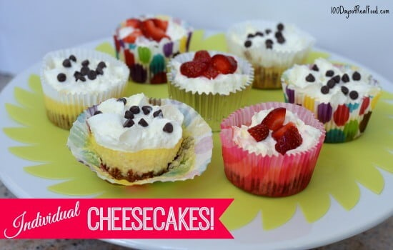 Individual Cheesecakes topped with chocolate chips and strawberries.