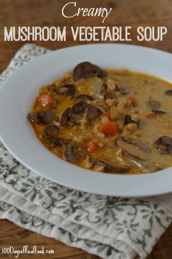 Large bowl of Creamy Mushroom Vegetable Soup with barley on a table.