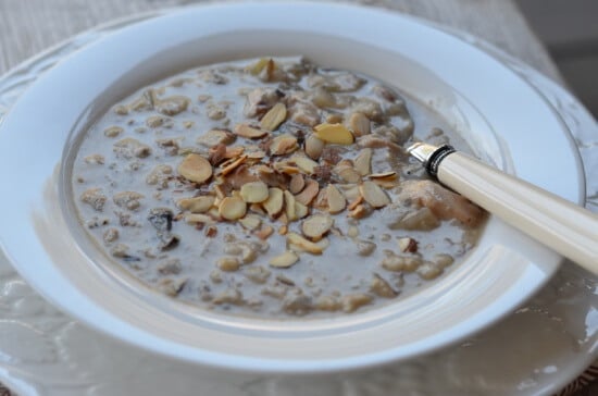Chicken and Wild Rice soup in a bowl topped with shaved almonds.
