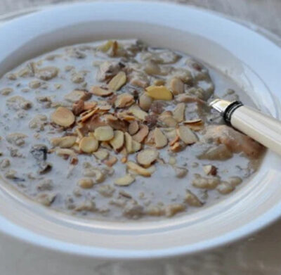 Chicken and wild rice in a white bowl with spoon.