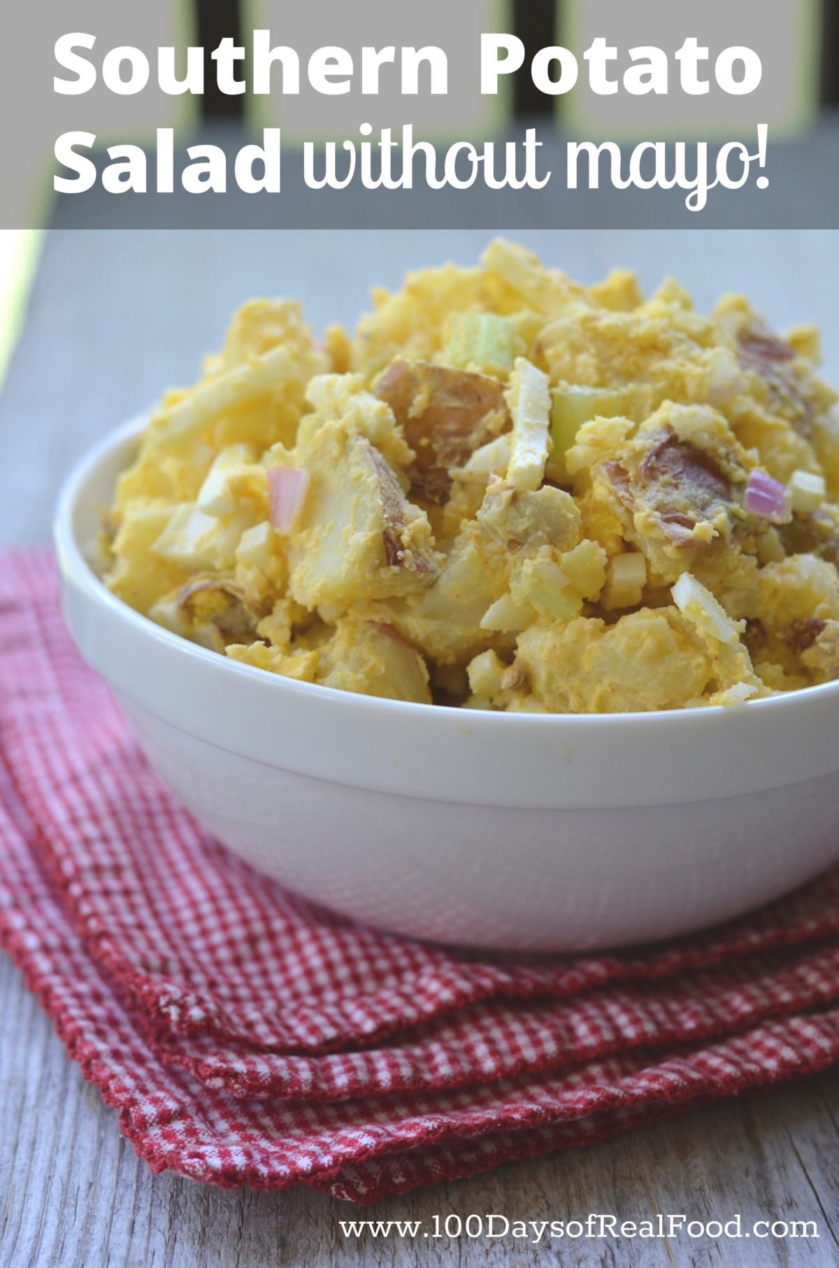 Southern Potato Salad in a white bowl sitting on top of a red and white napkin.