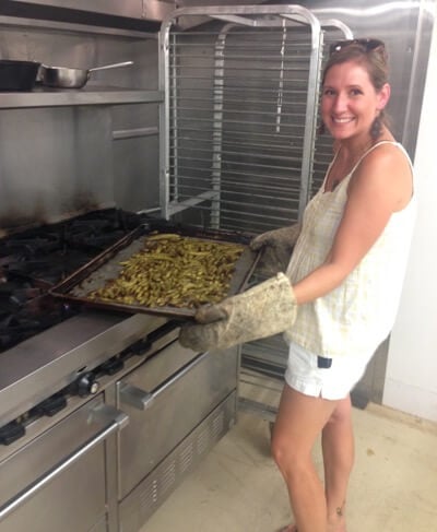 Amy Bishop from Greenbrier Farms pulling out roasted okra from the oven.