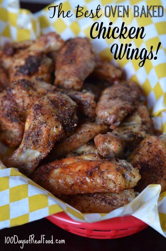 Oven baked wings in a red basket and yellow checkered paper.