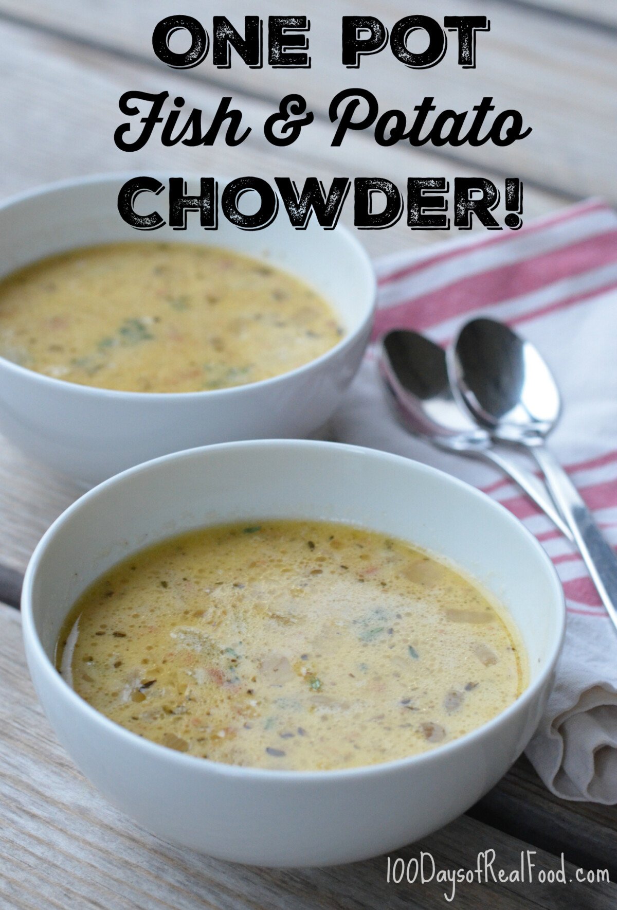 Tow bowls of Fish and Potato Chowder sitting on a table with a red and white stripped towels and two spoons.