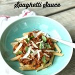 Bowl of Semi-Homemade Spaghetti Sauce served over pasta topped with herbs and Parmesan cheese