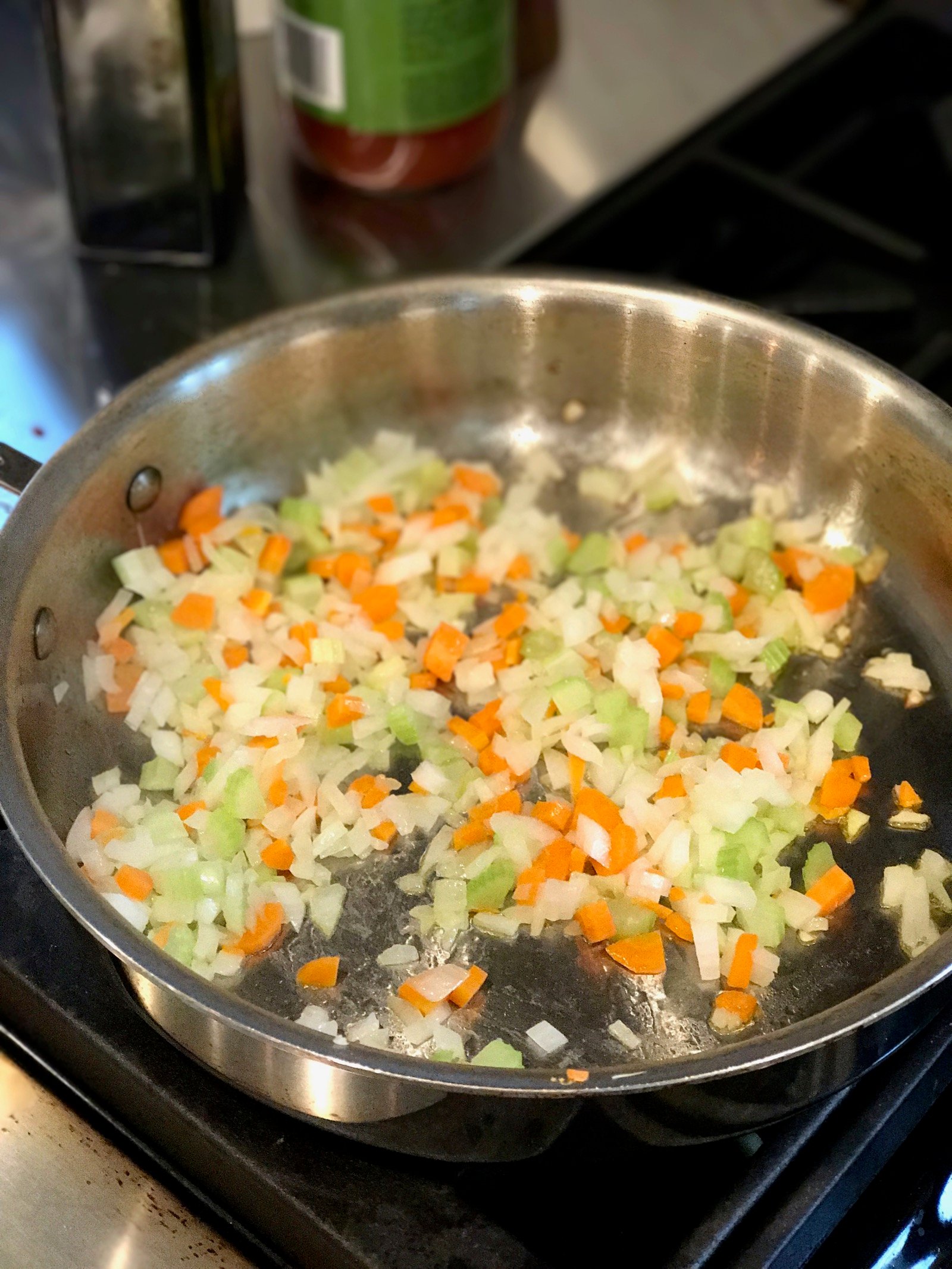 Cooking onions, celery, and carrots to make semi-homemade spaghetti sauce