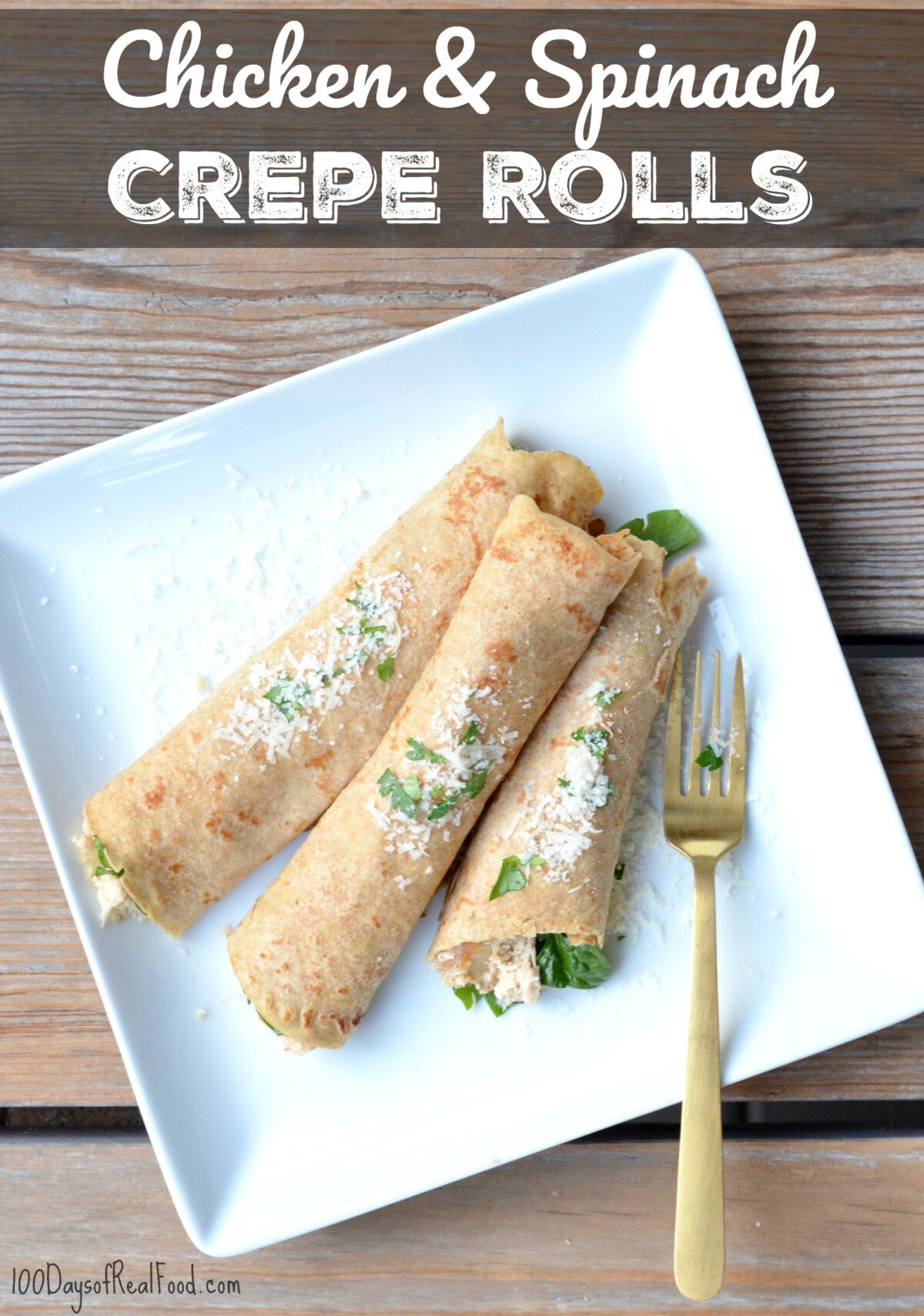 Three crepes rolled up on a dinner plate with chicken and spinach filling.