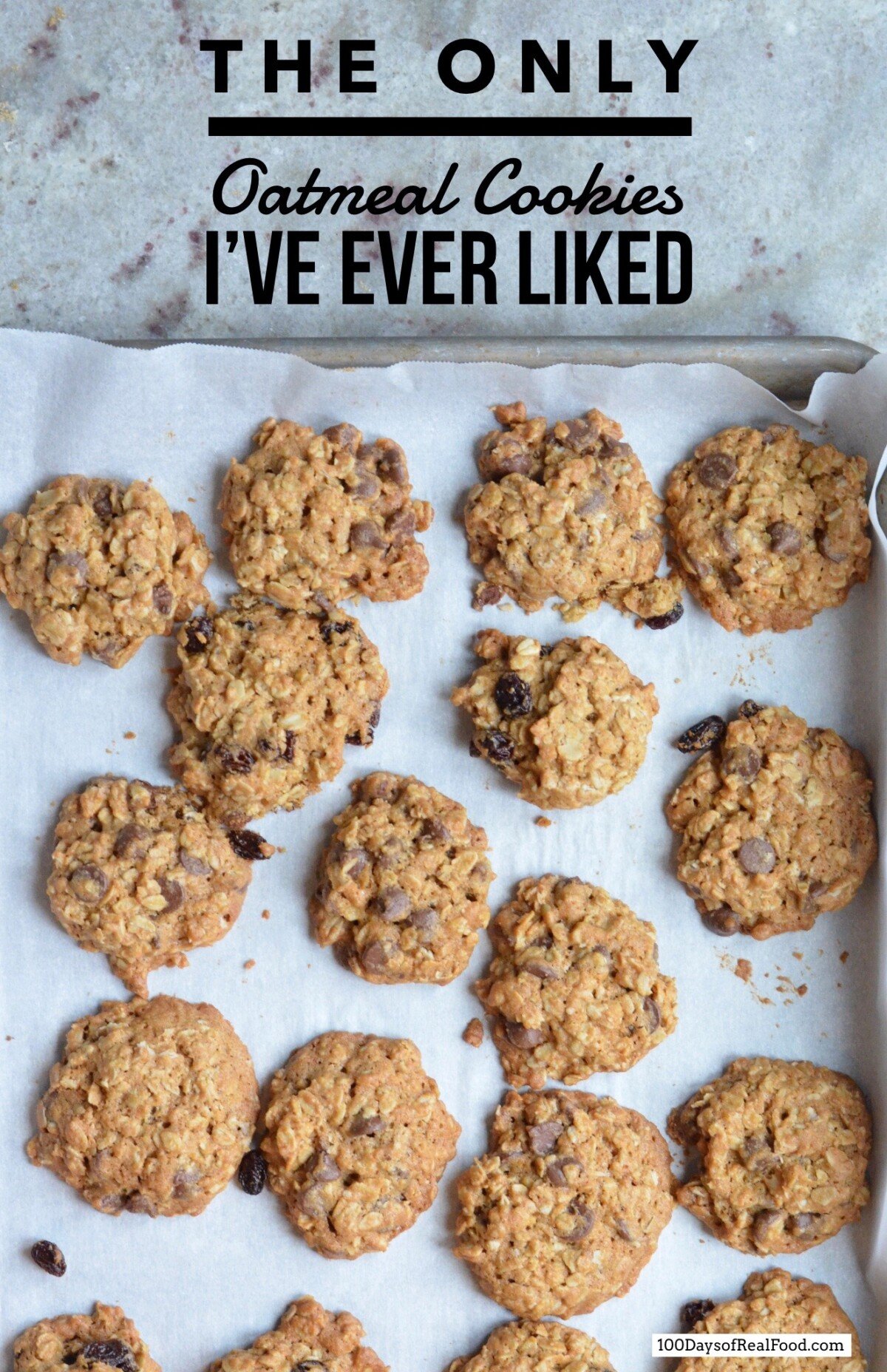 Homemade oatmeal cookies on a baking sheet lined with parchment paper.