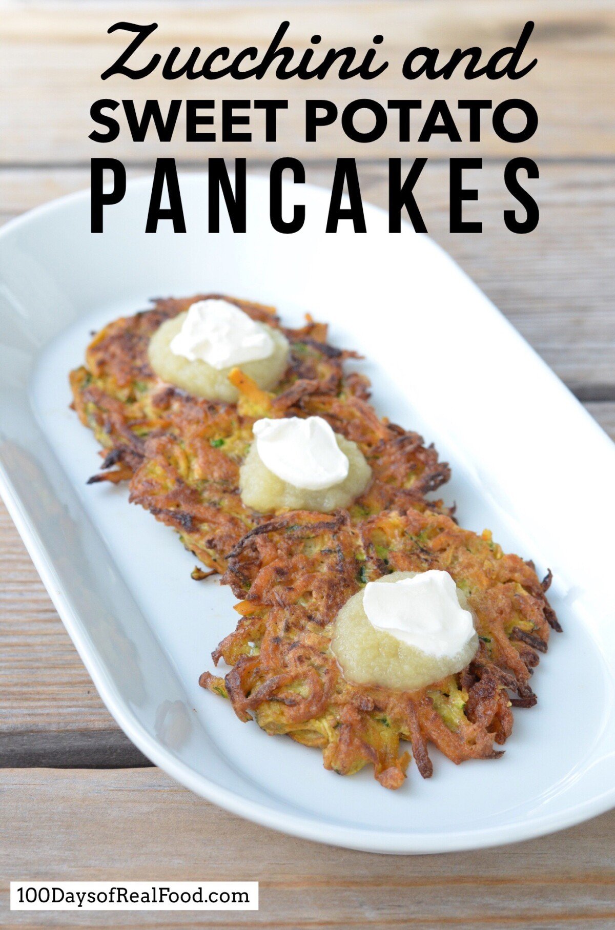 Three Zucchini and Sweet Potato Pancakes with applesauce and sour cream on top.