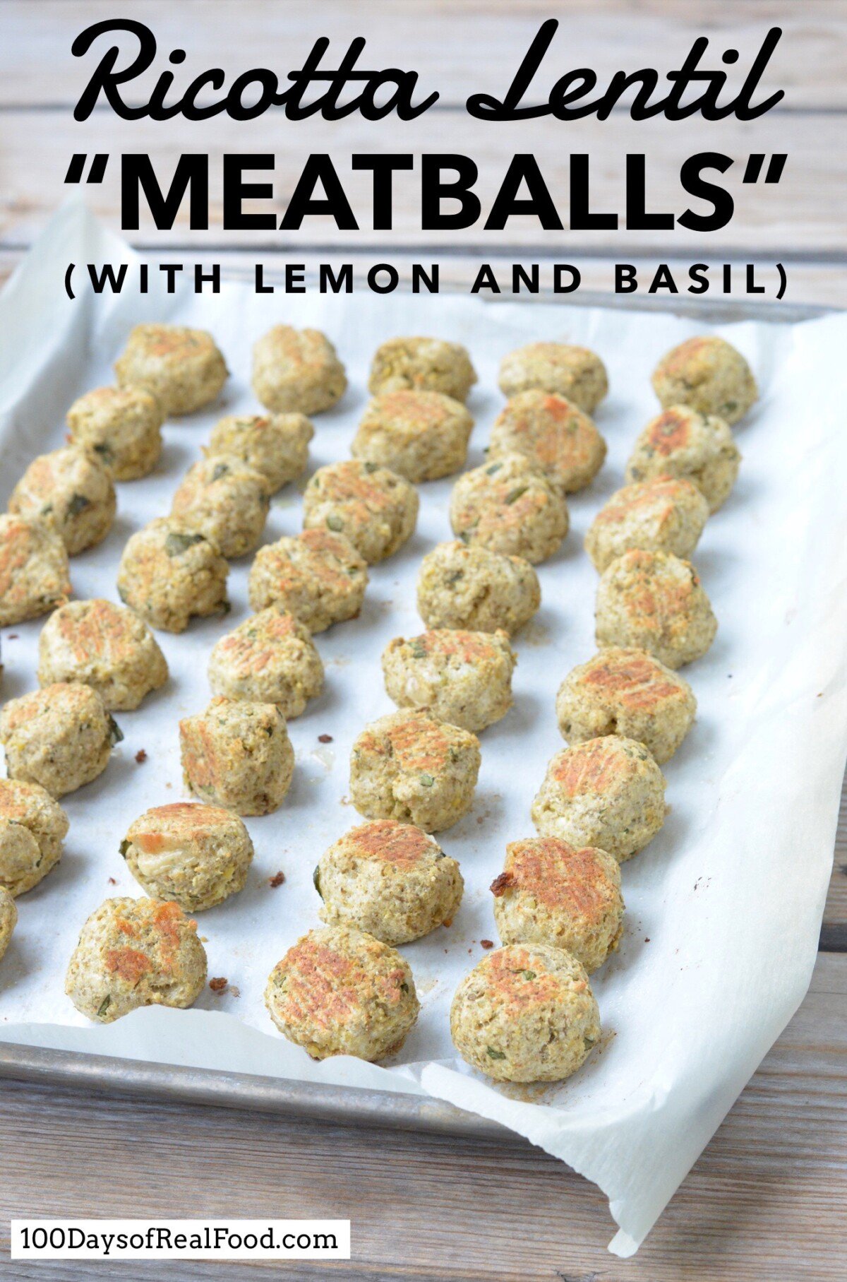 A sheet pan lined with parchment paper with rows of baked Ricotta Lentil Meatballs with Lemon and Basil.