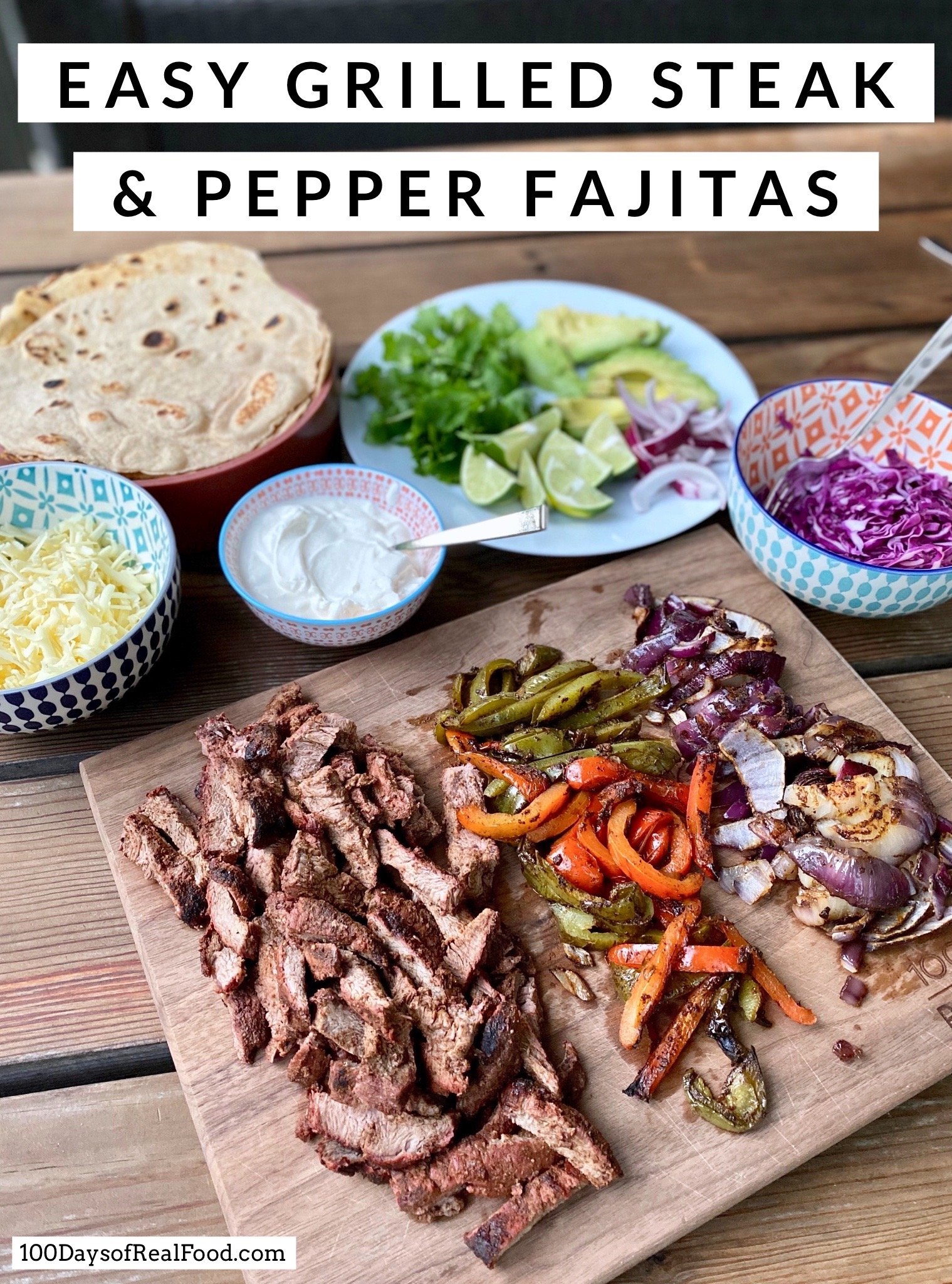 Grilled Steak and Pepper Fajitas on a cutting board with additional serving suggestions