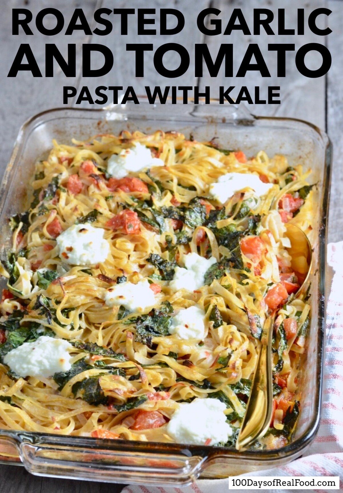 Roasted Garlic and Tomato Pasta with Kale topped with mounds of melted cheese in a baking dish. 