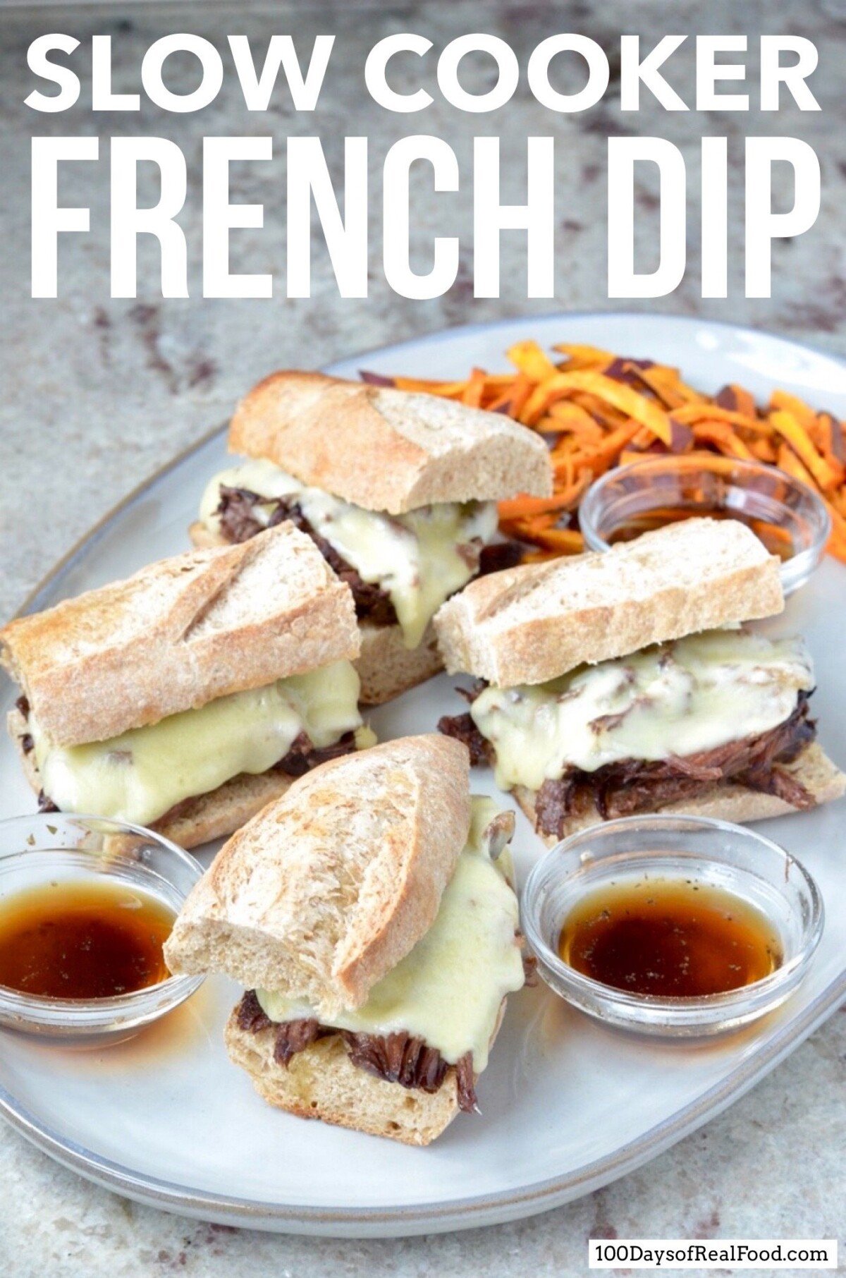 Slow Cooker French Dip Sandwiches topped with melted cheese, a side of au jus and sweet potato fries.