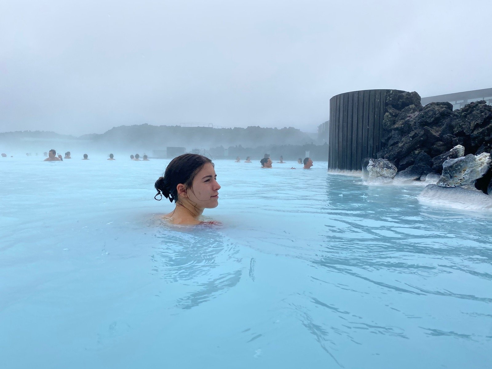 Teen girl swimming in the Blue Lagoon in Iceland.
