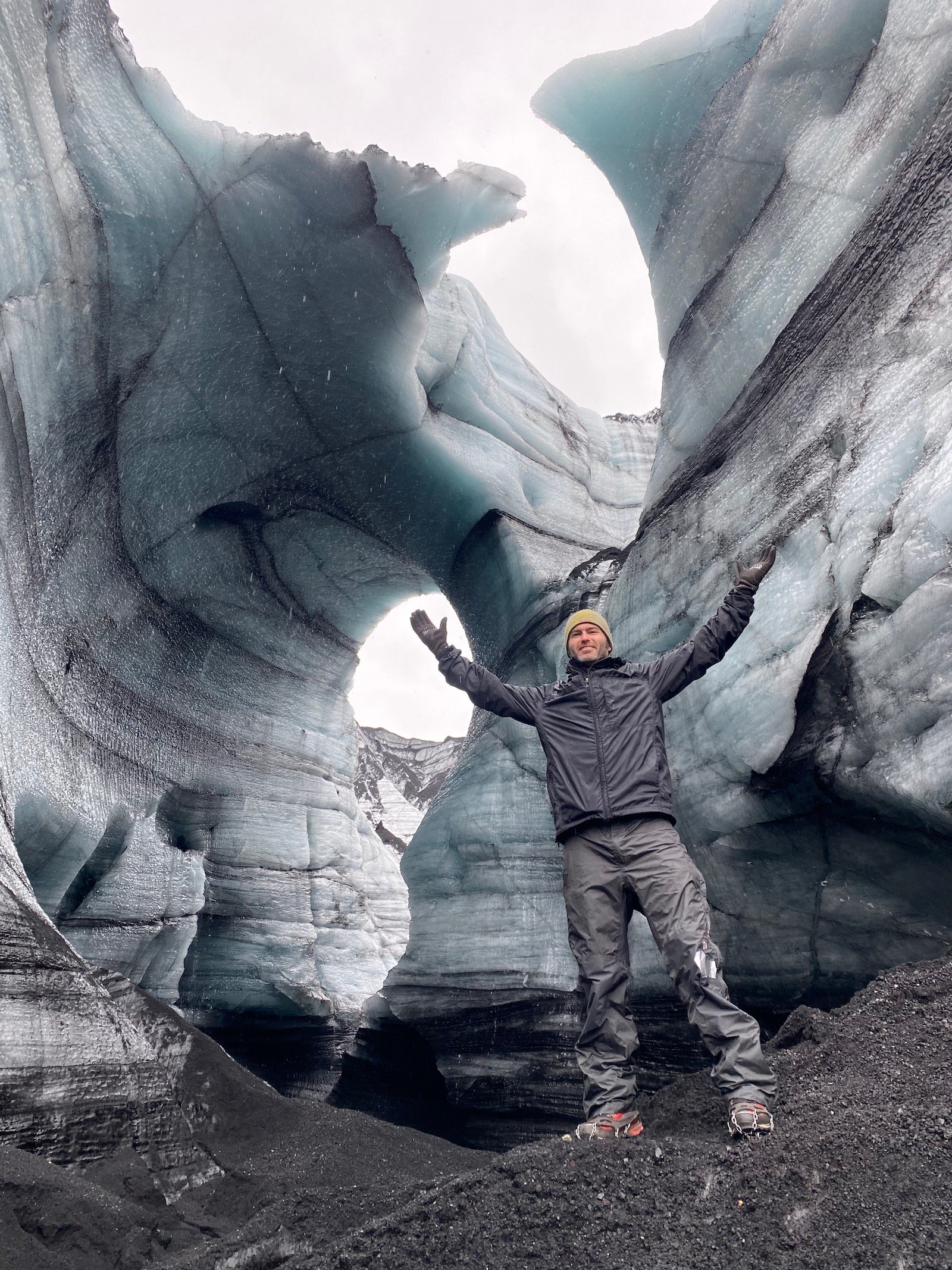 Father posing in ice caves in Iceland.