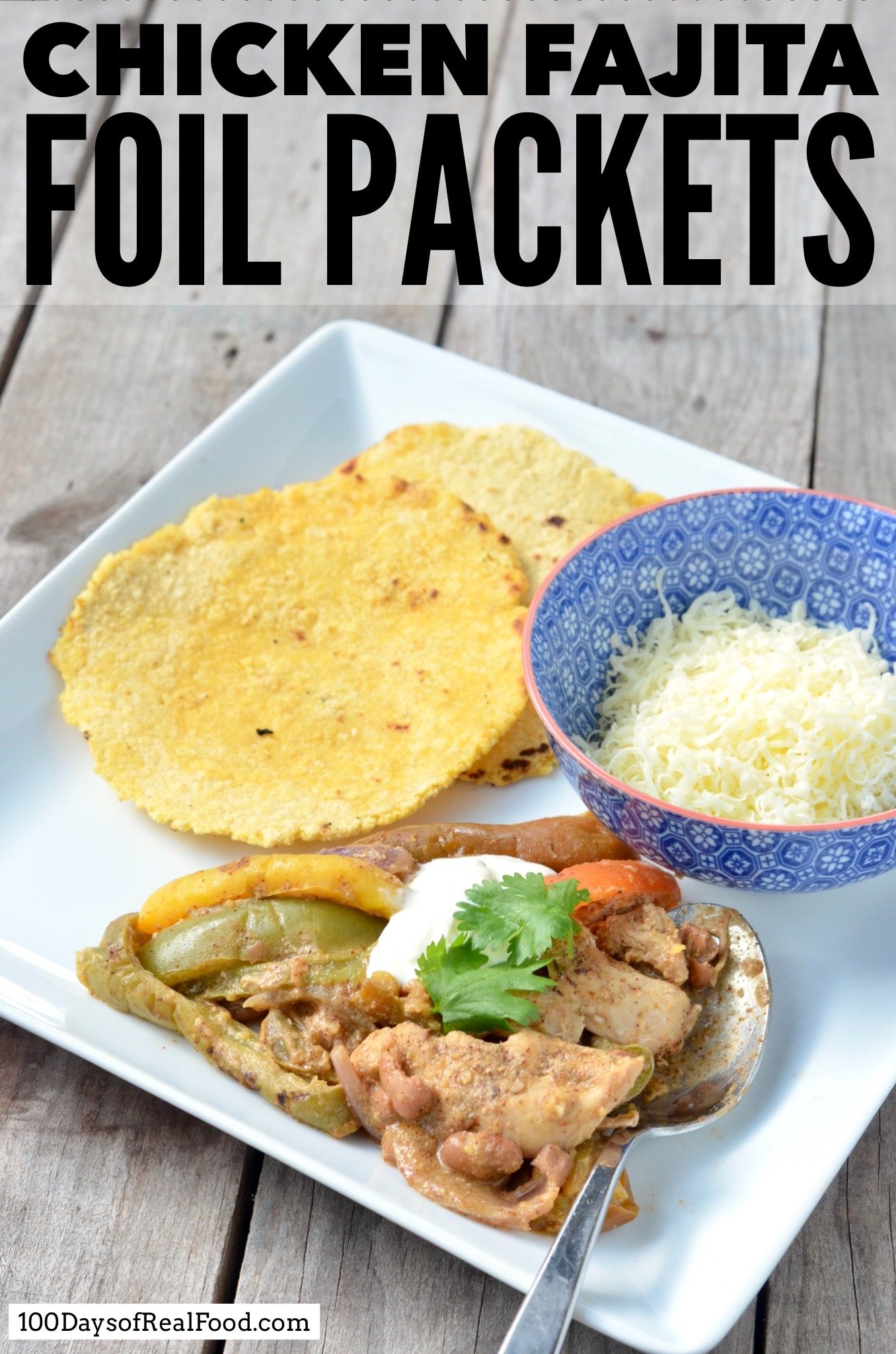 A plate of chicken fajitas served with homemade corn tortillas and a bowl of cheese.
