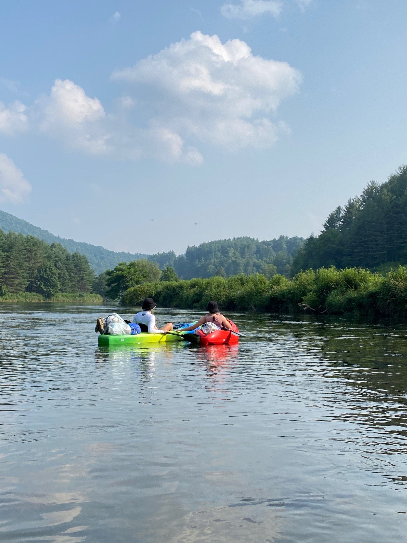 Two people in kayaks on a river in North Carolina.