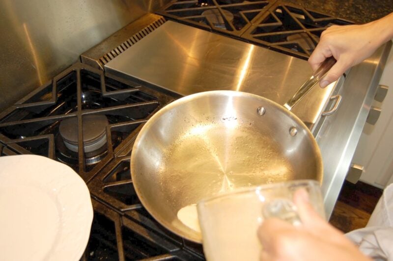 Pouring whole wheat crepe batter into a frying pan