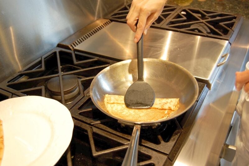 Rolling up whole wheat crepes after cooking