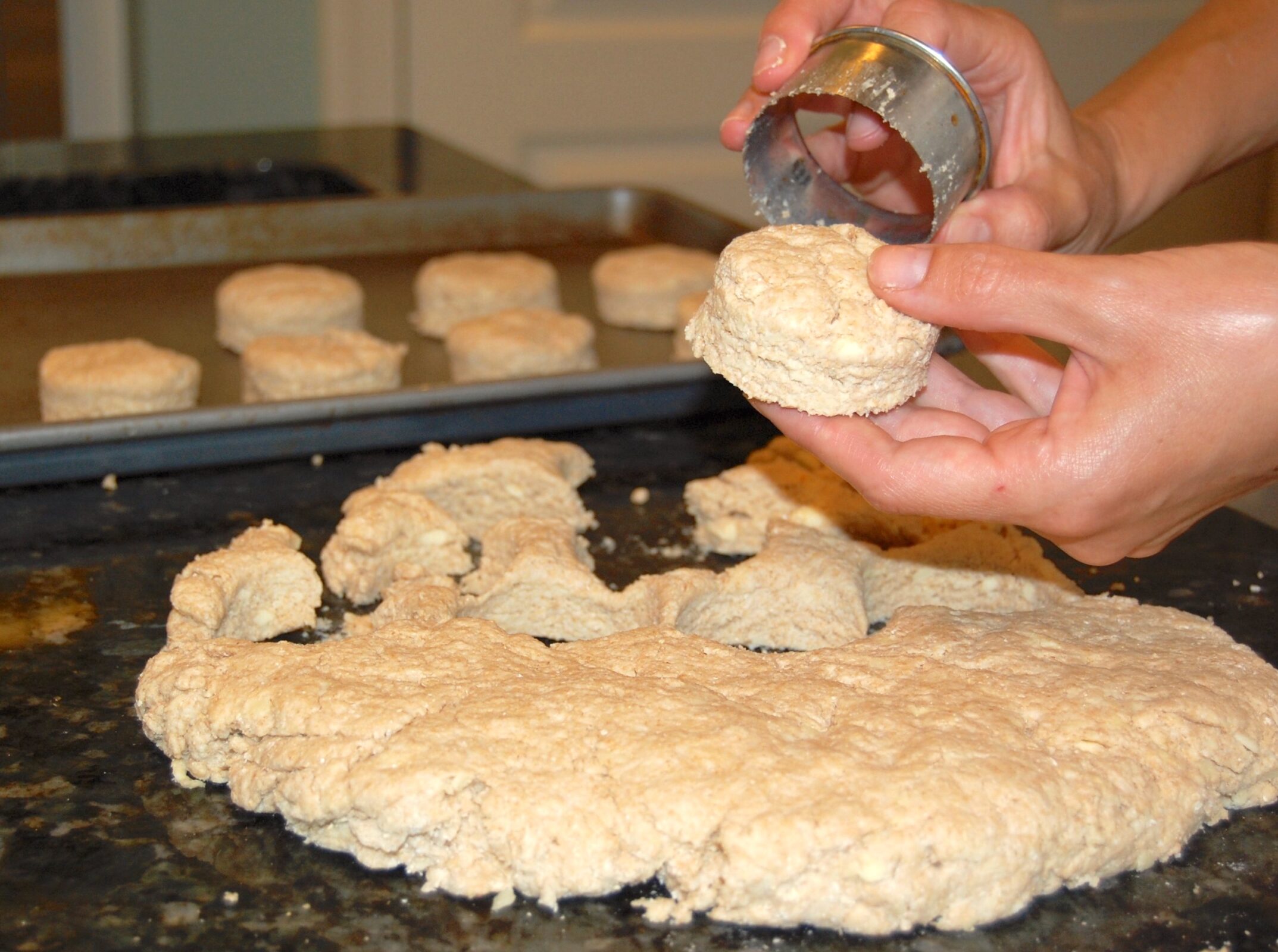 cutting out homemade biscuits with a cookie cutter