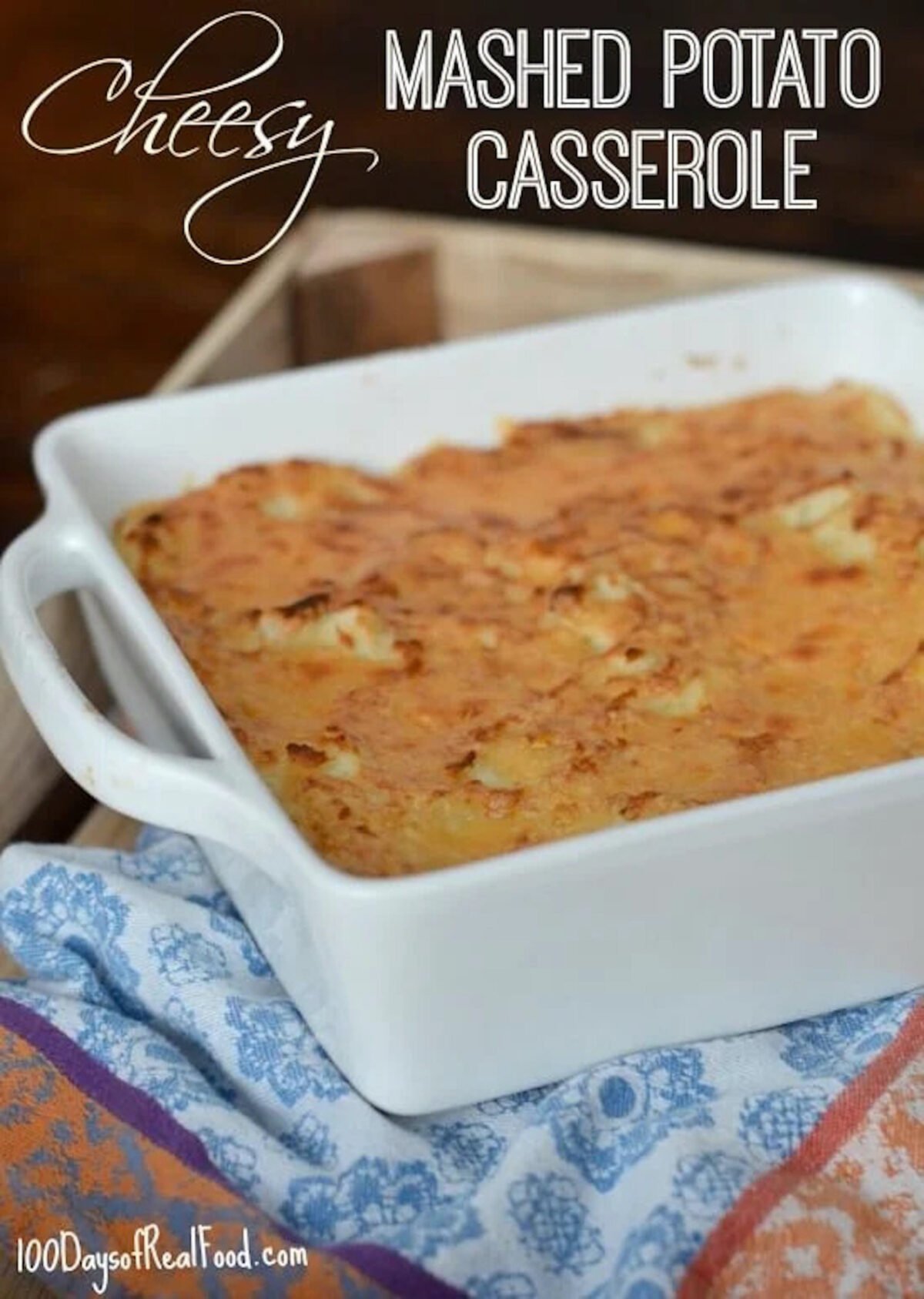 Cheesy mashed potatoes in a white casserole dish. 