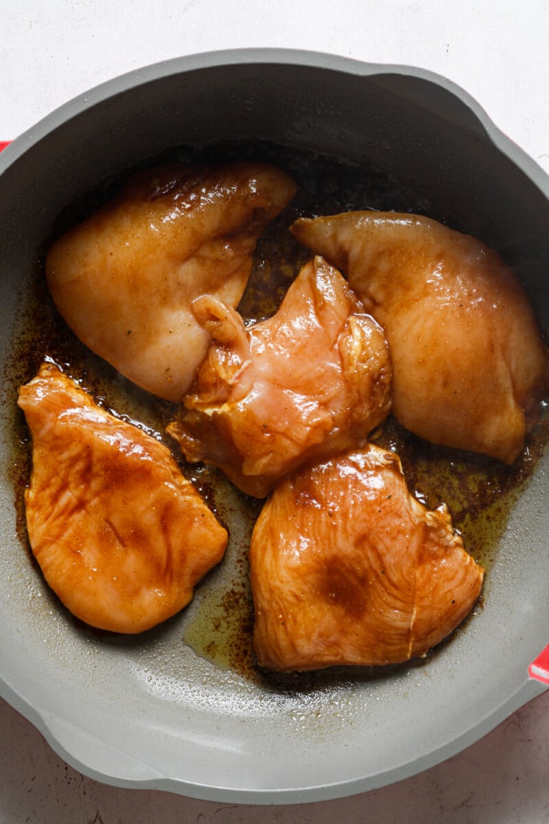 Chicken and sauce in skillet.