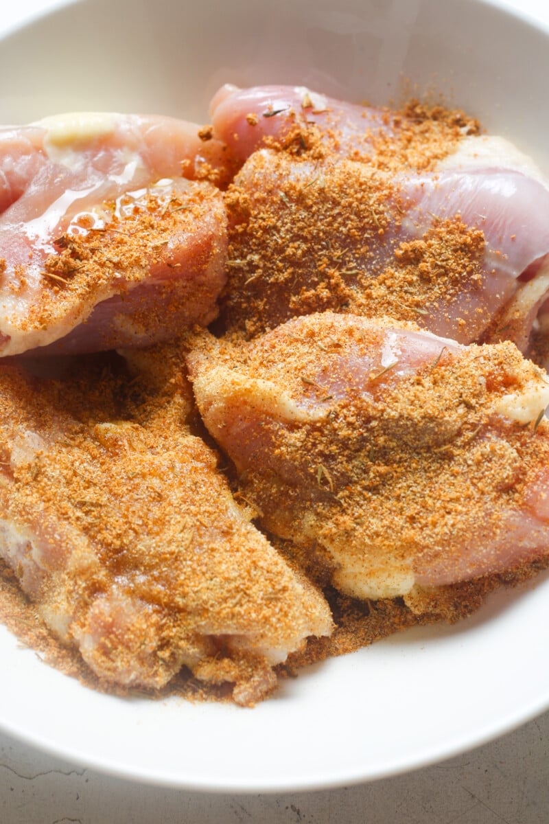 Chicken thighs with seasonings.