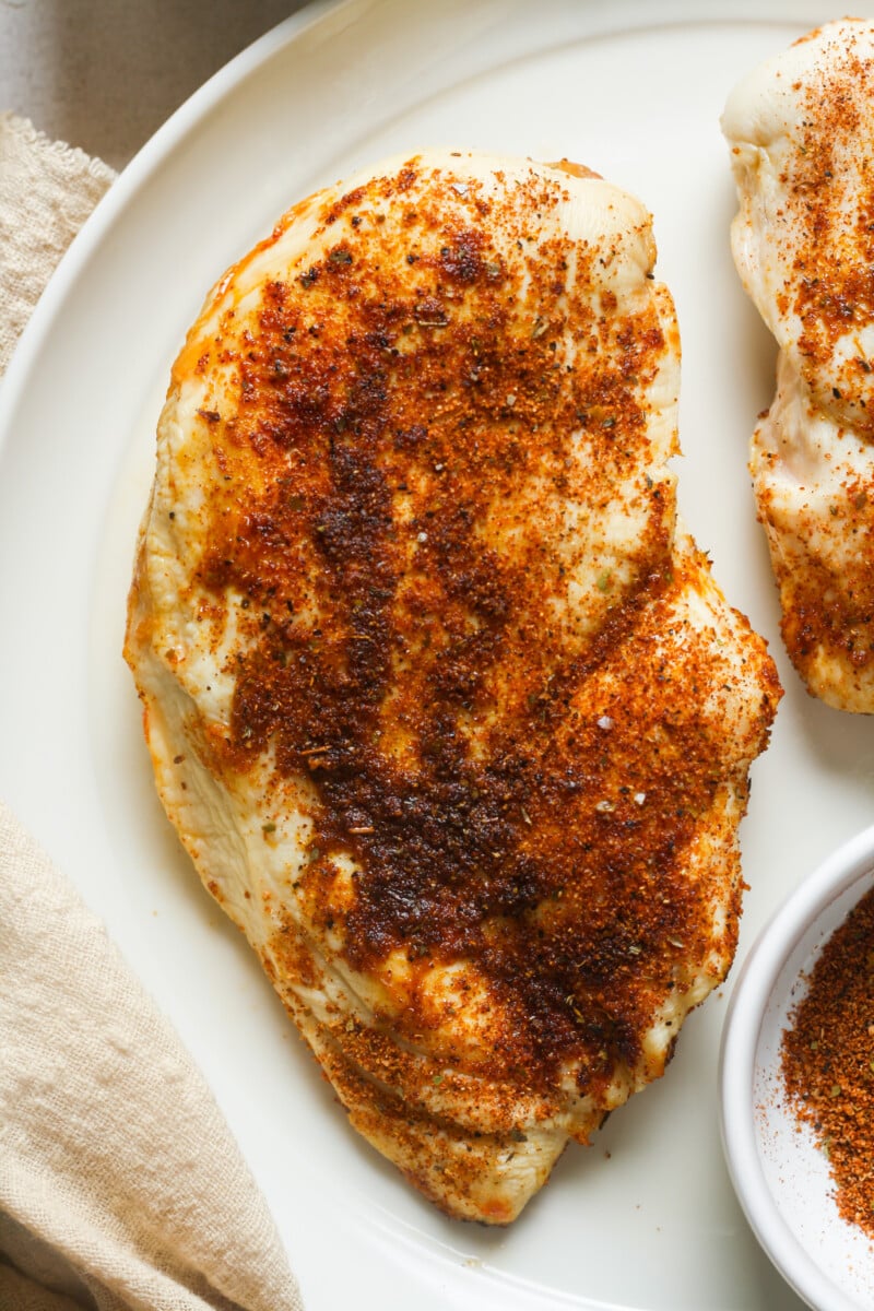 Seasoned chicken on plate.
