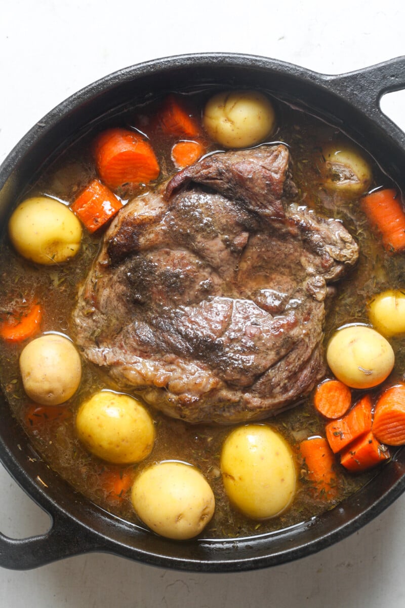 Meat in cast iron oven.
