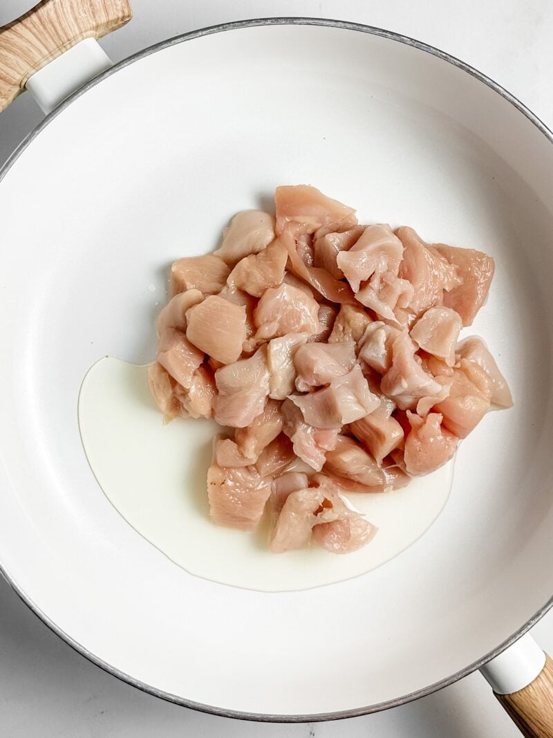 Cubed chicken in pan.