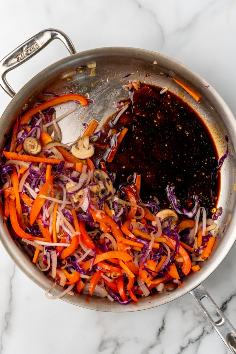 Veggies with soy sauce in pan.