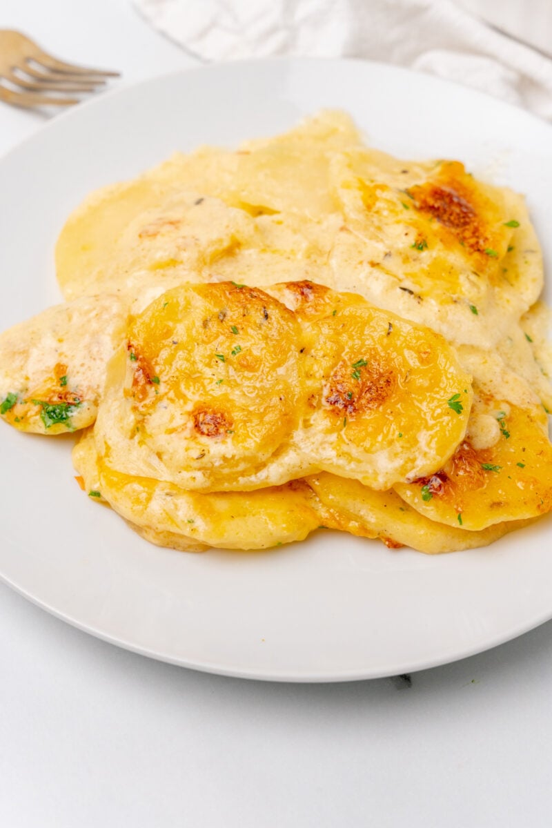 Scalloped potatoes on a plate.