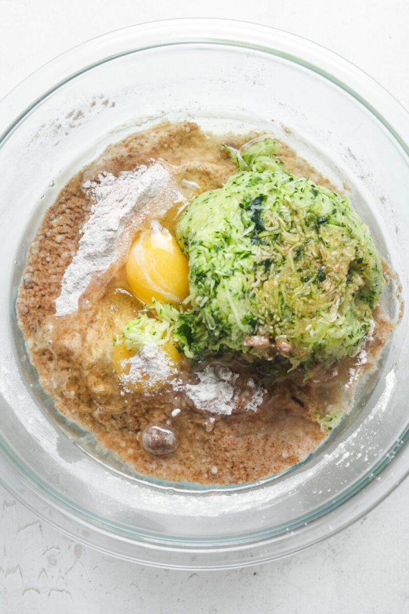 Grated zucchini and eggs in bowl.