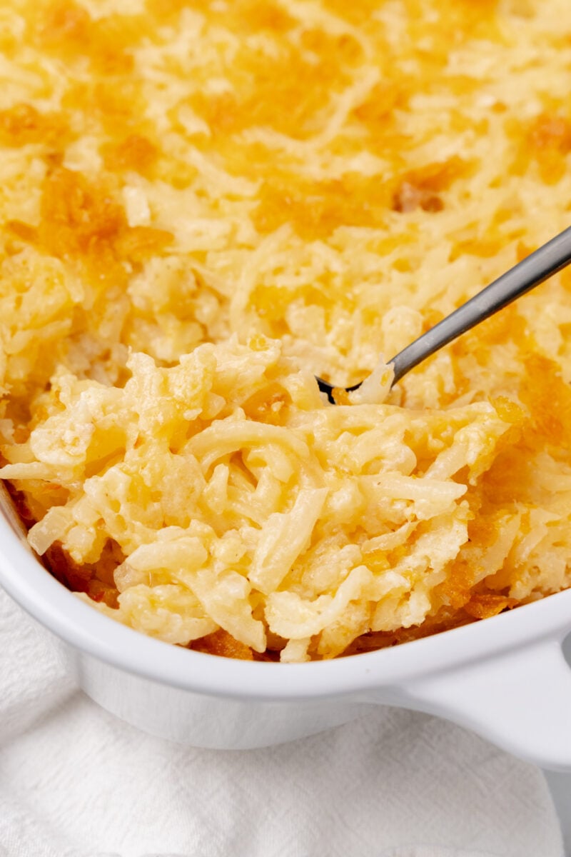 Spoonful of hash brown casserole.