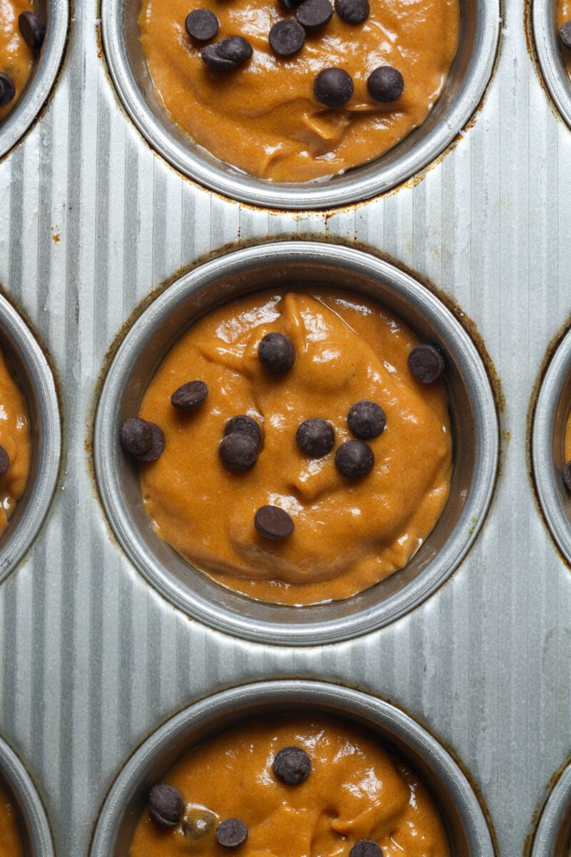 Muffin pan with raw batter.