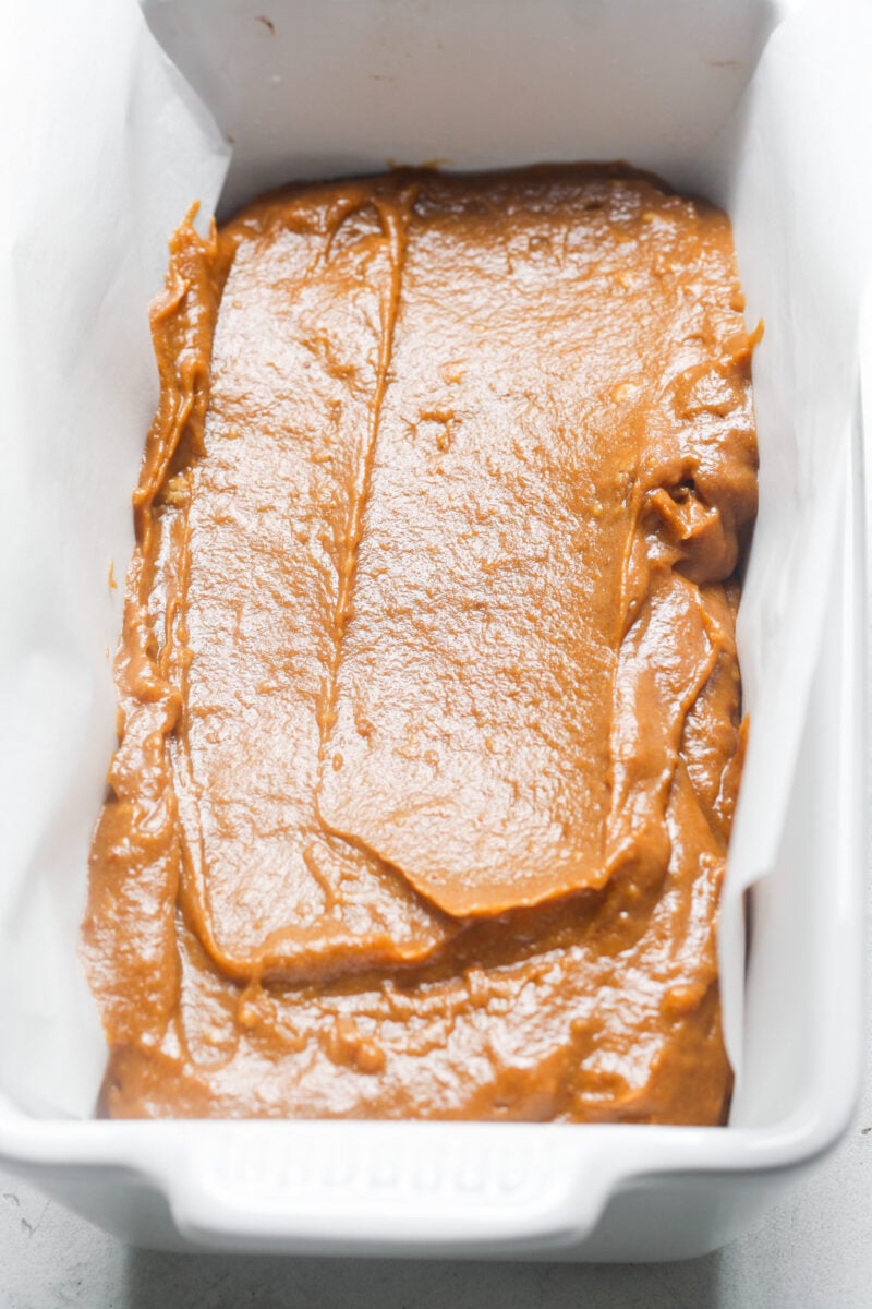 Loaf pan with orange batter.