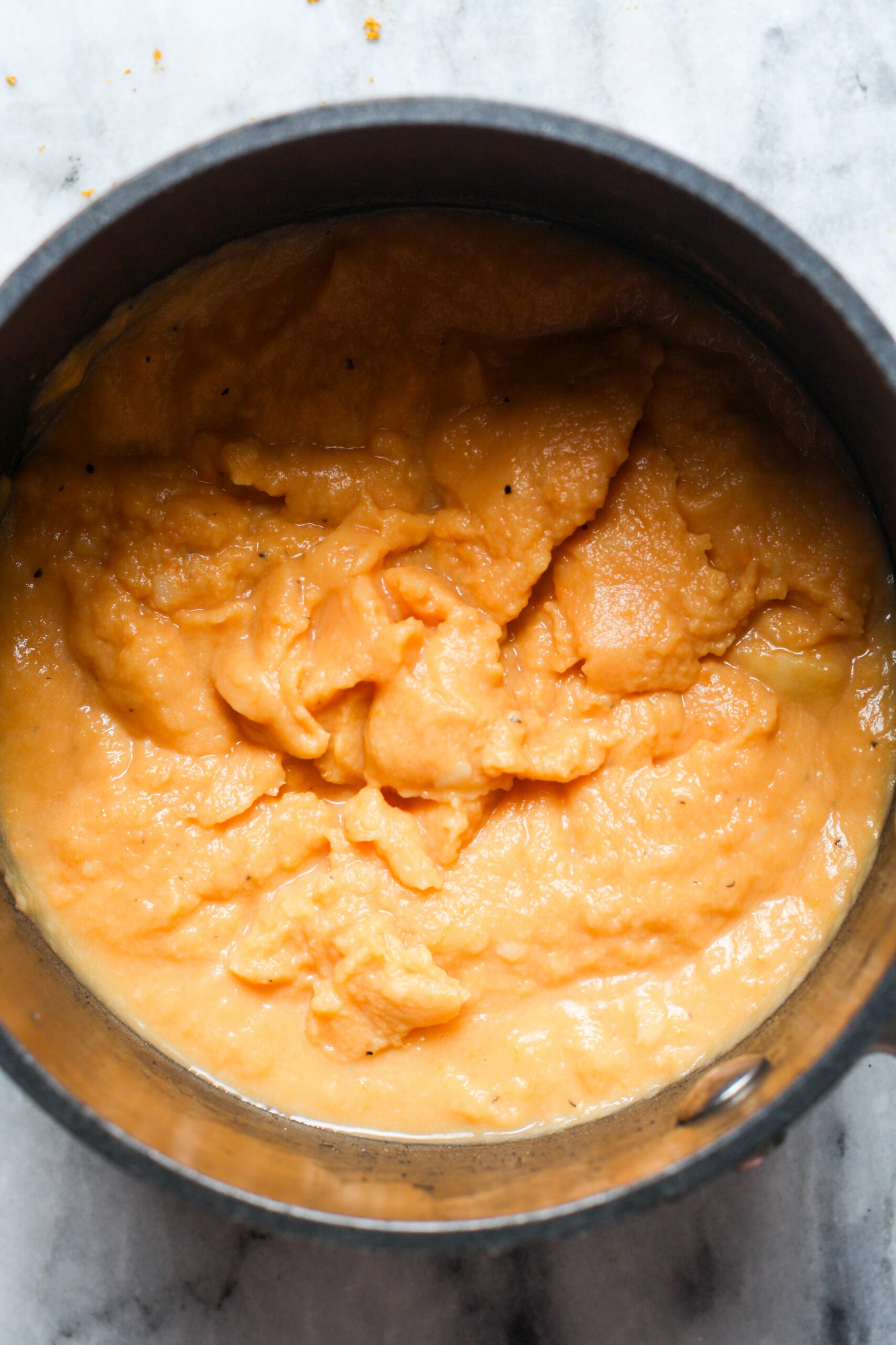 Creamy sweet potatoes in pan.