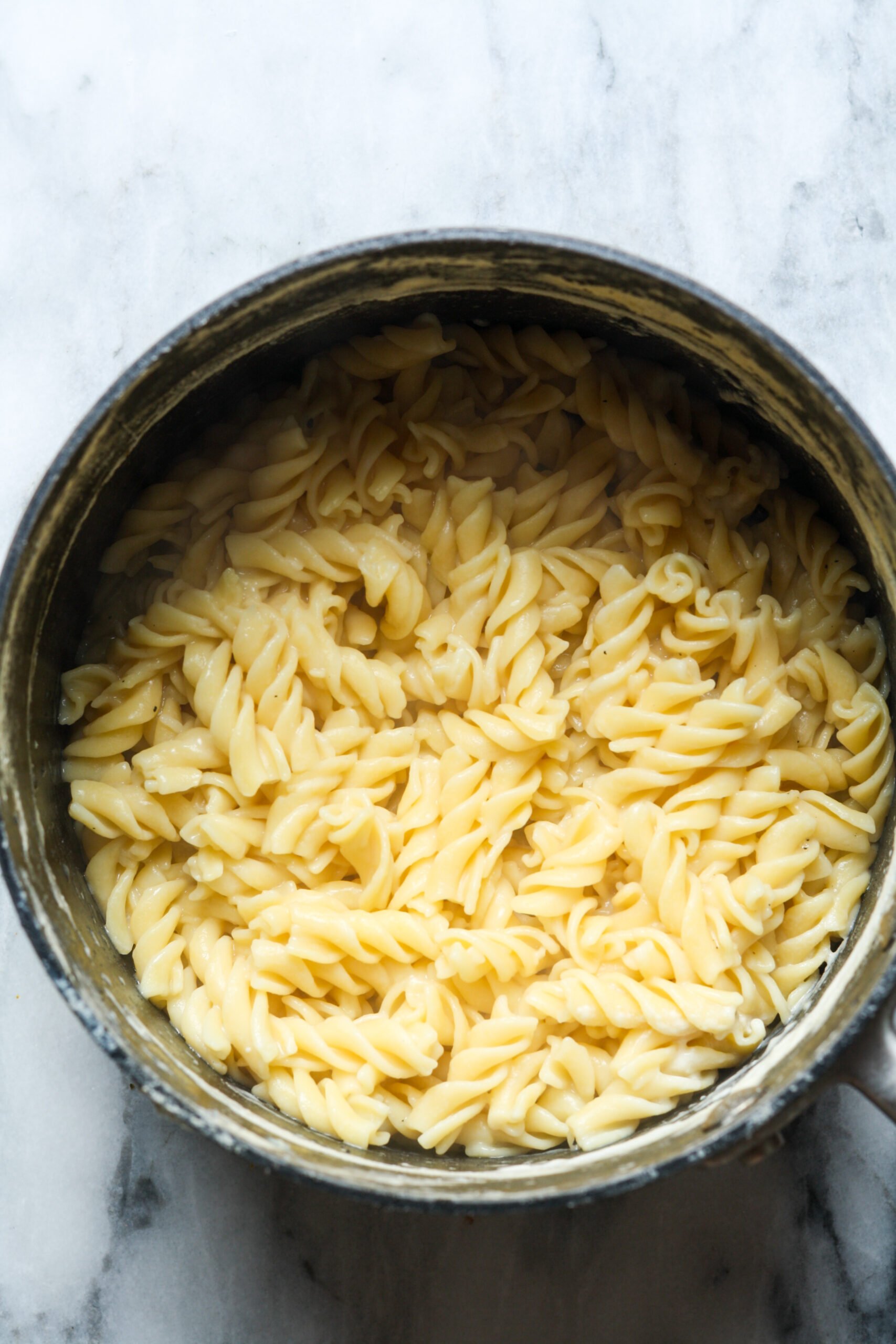 Cooked noodles in pan.