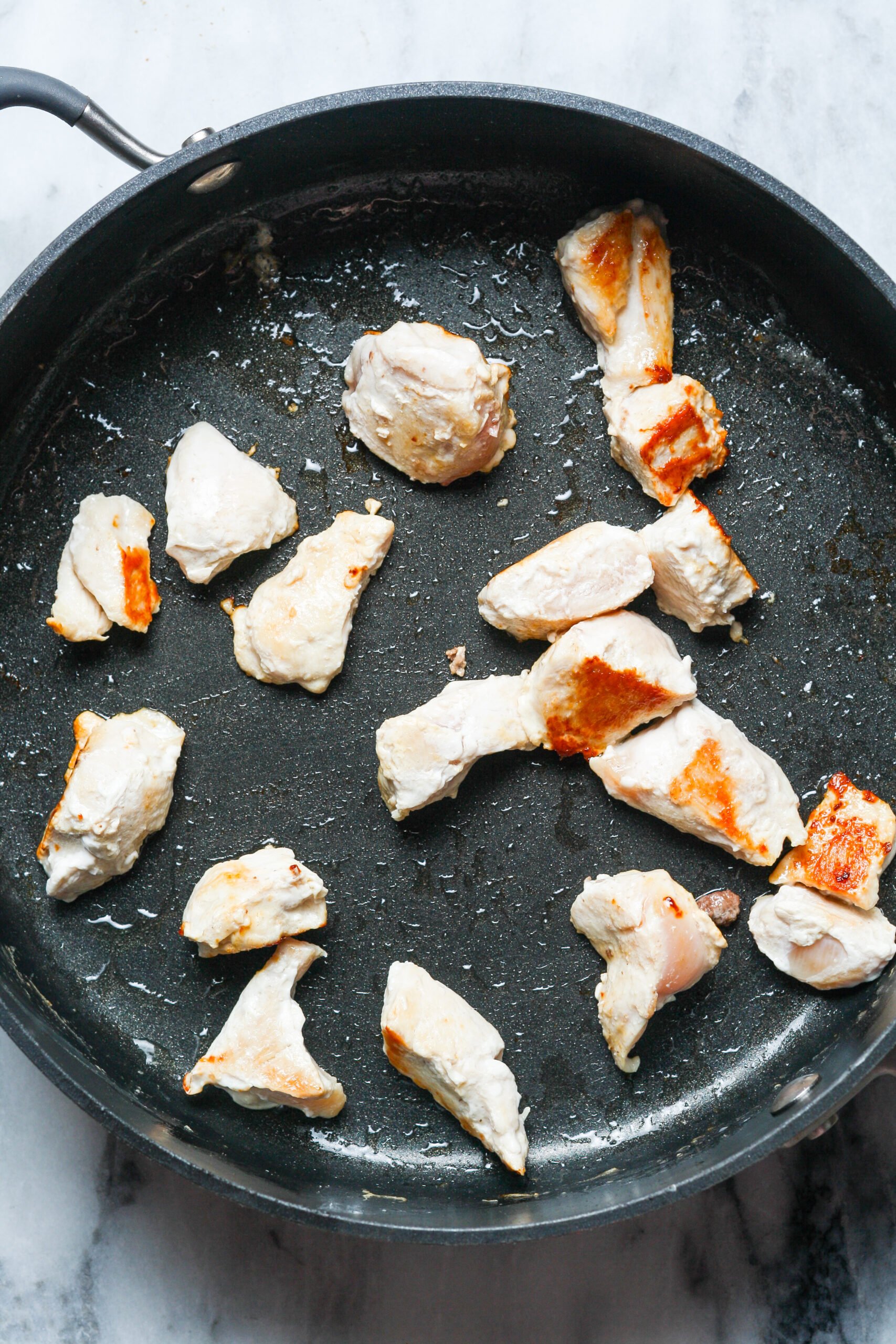 Pan with chicken cubes.