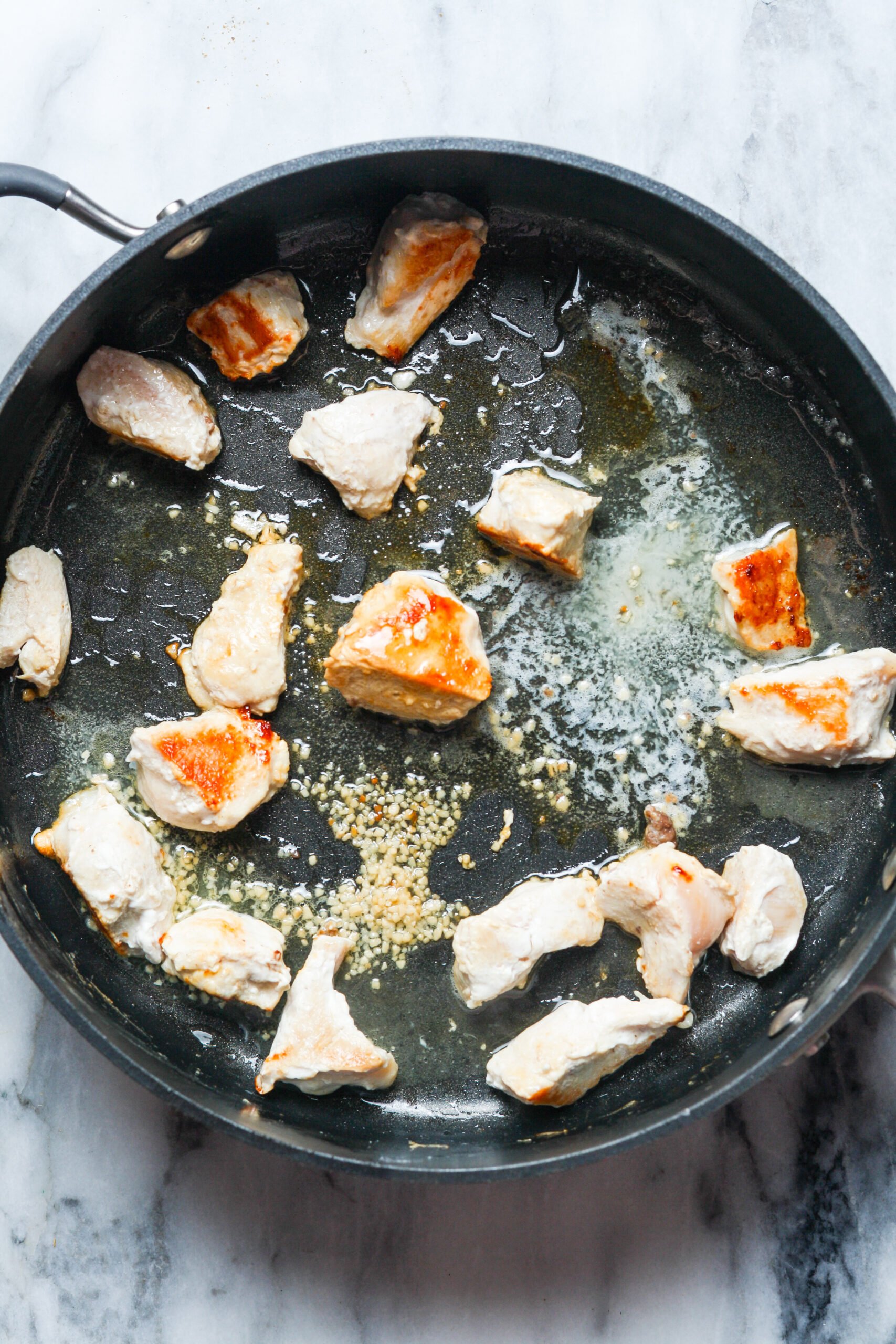 Garlic butter meat in skillet.