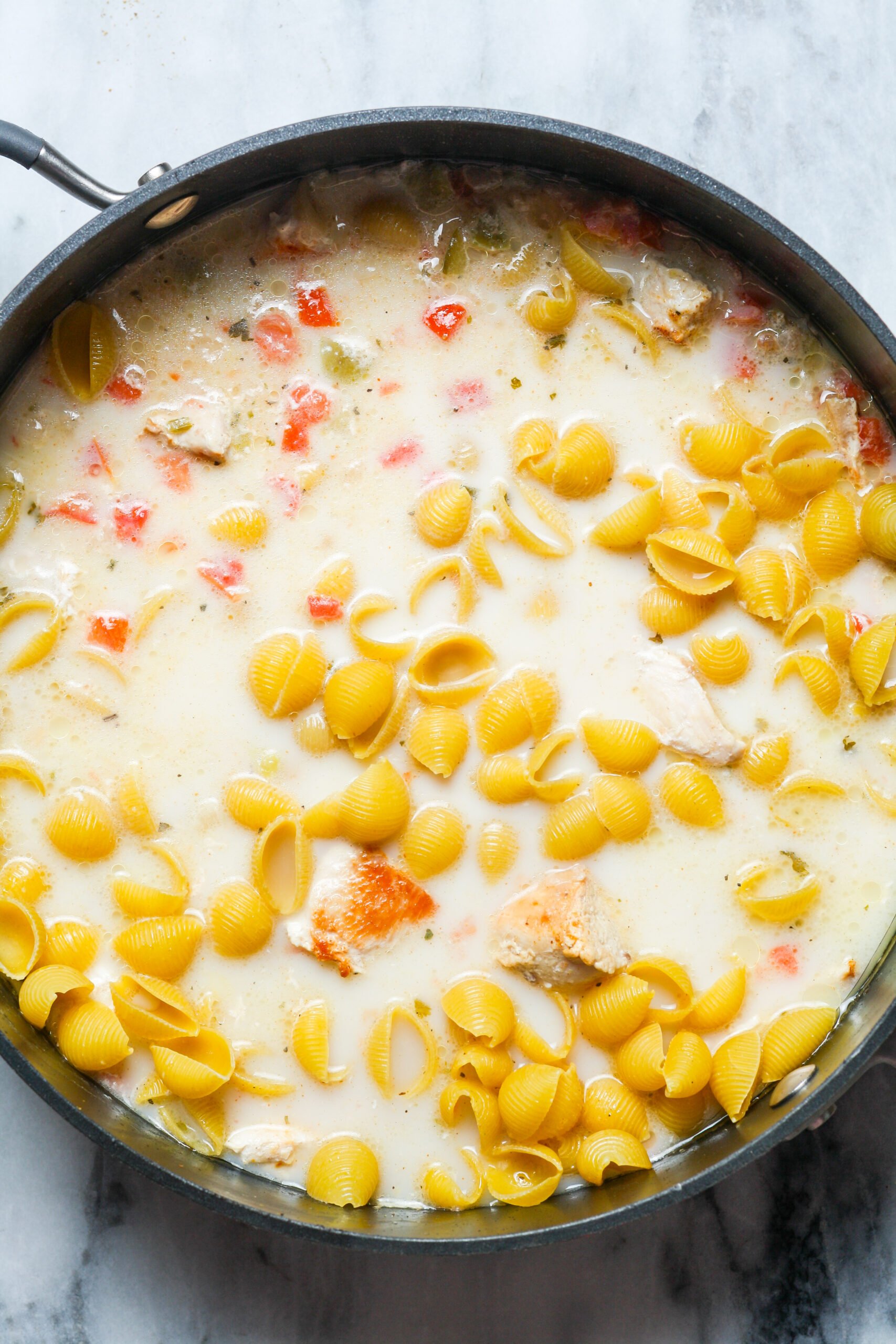 Milk with pasta in pan.